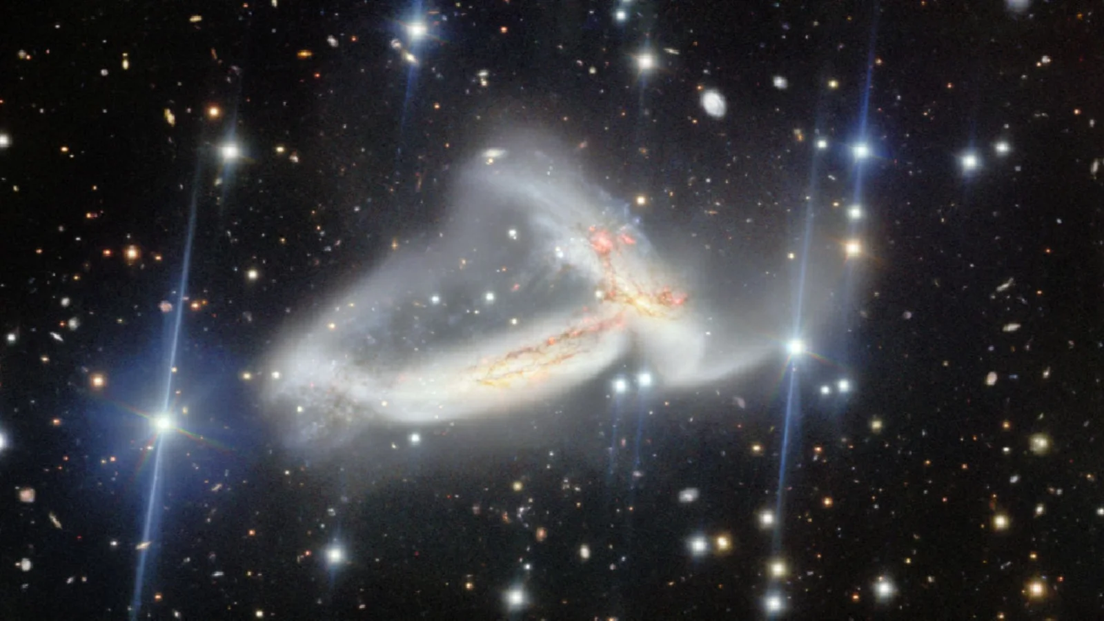 Cosmic tango: twin galaxies merge in NGC 7253, igniting star birth