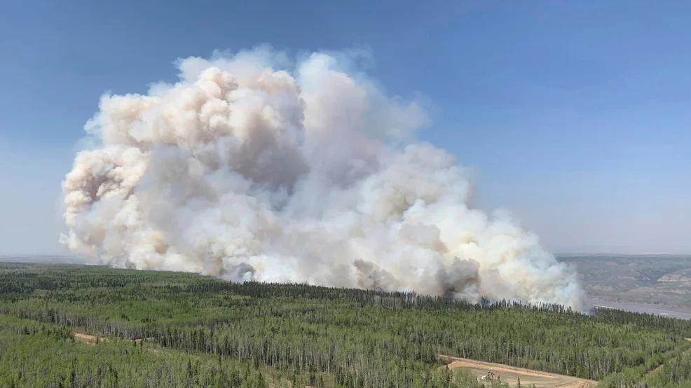 Wildfire smoke blankets Northeastern US, causing hazy skies.