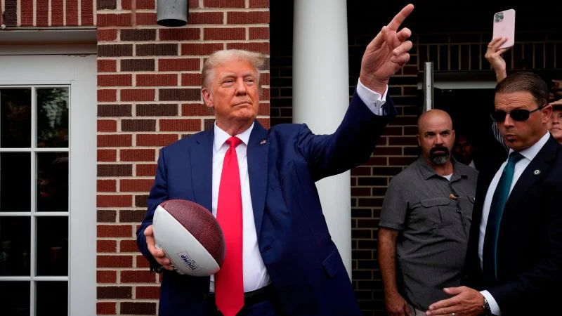 "Trump Makes Strategic Appearance at South Carolina College Football Game"