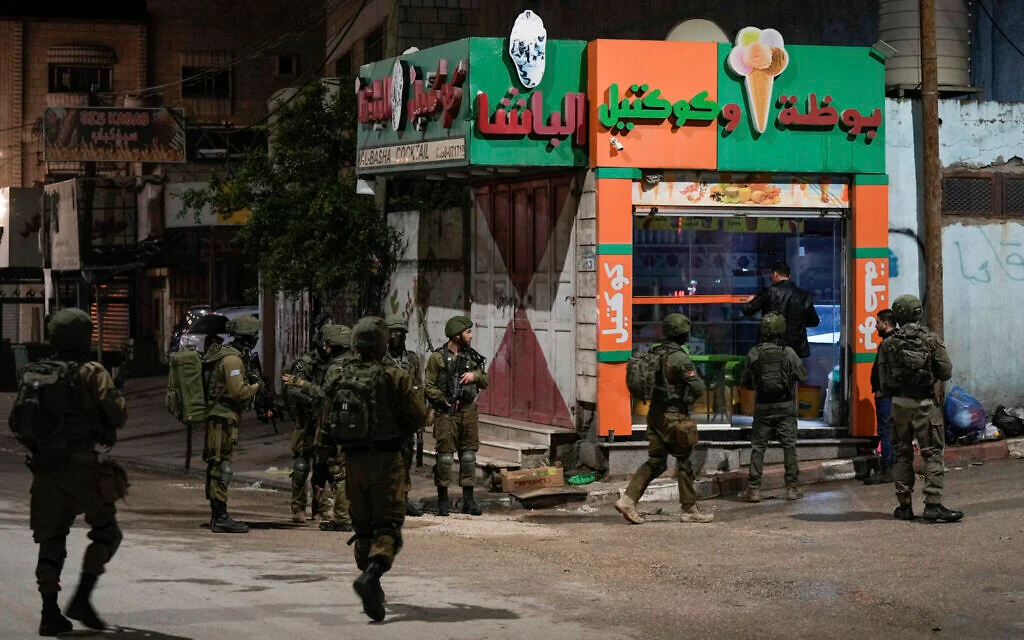 Israeli forces kill two Palestinian gunmen in West Bank raid.