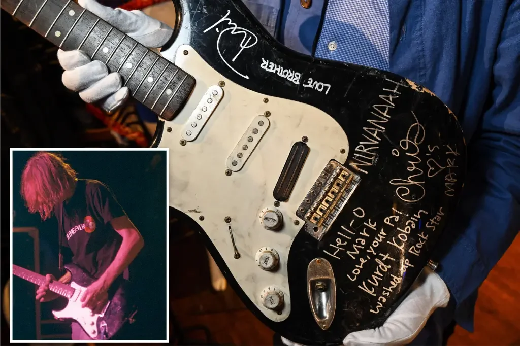 Kurt Cobain's smashed guitar sells for almost $600K at auction.
