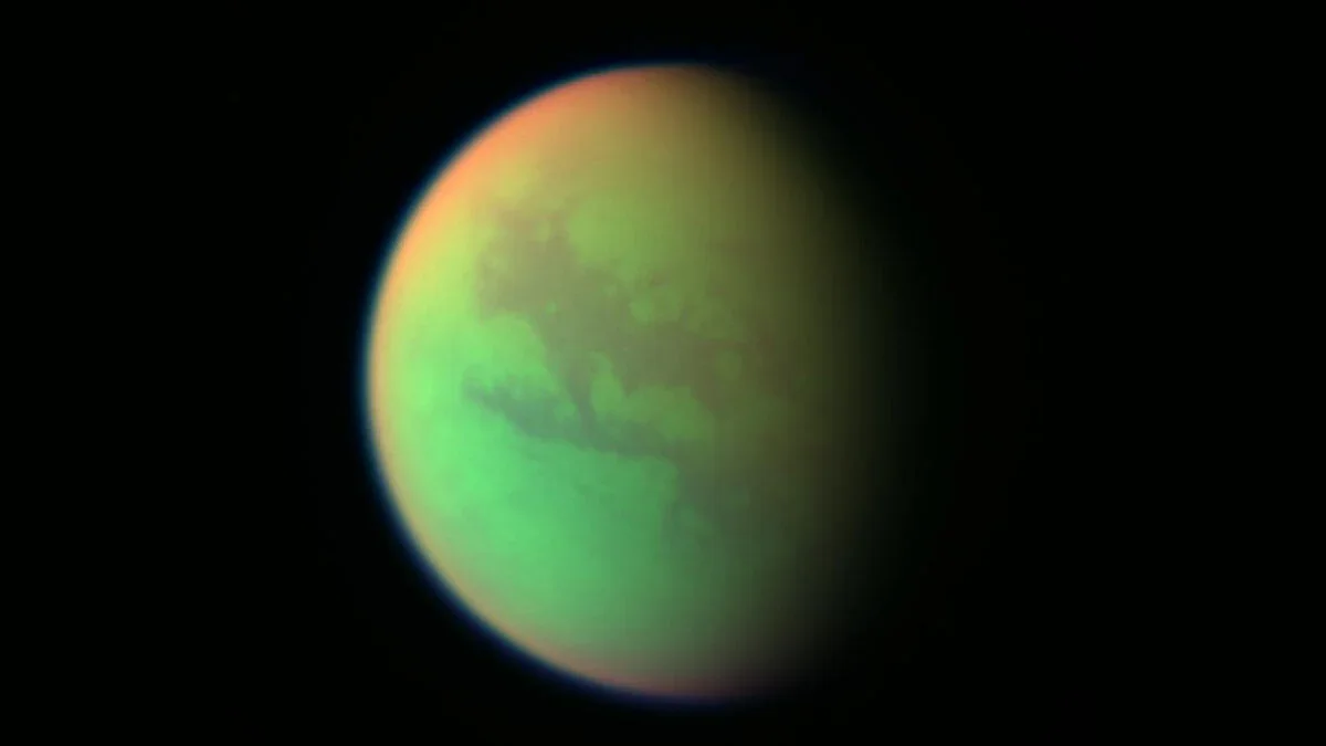 Hidden Molecule Behind the 5.11-Micrometer Signature on Pluto and Titan