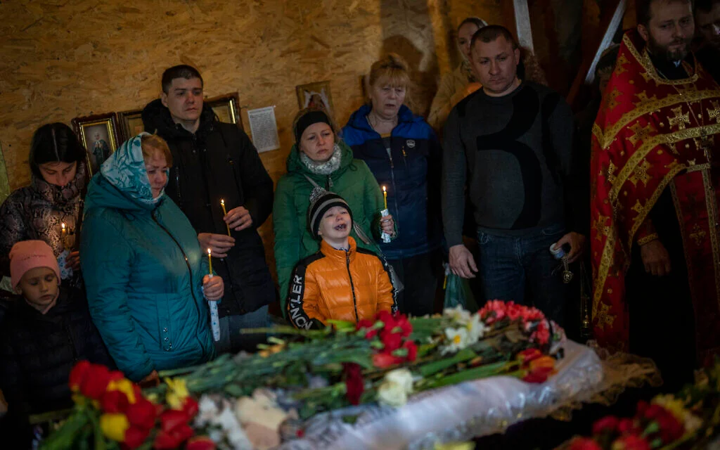 Mourners lay to rest victims of Uman missile attack.