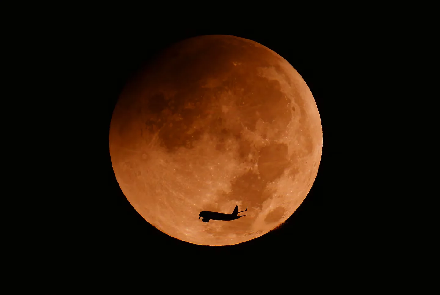 Crimson Moon Dazzles the World in Partial Eclipse Photo Tour