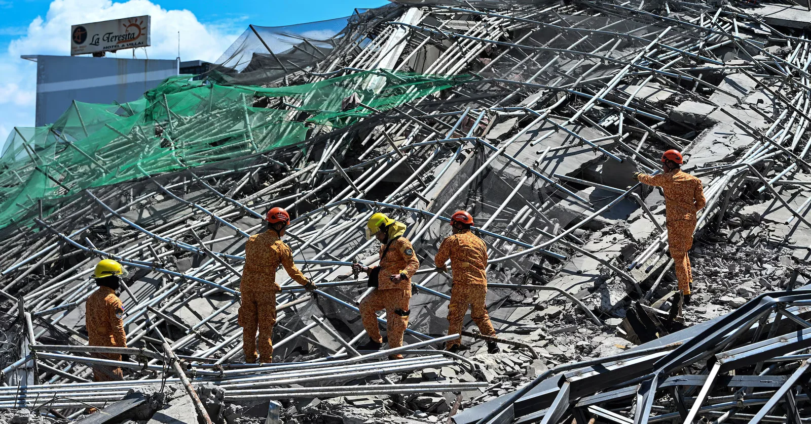 Rescuers race to reach 23 trapped after nine-story Philippines building collapse