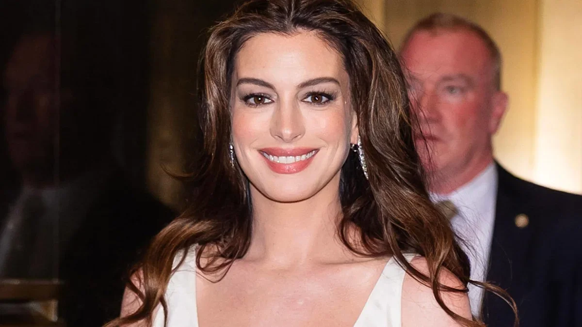 Anne Hathaway radiates maternity glow in bridal-white gown on Odyssey press tour