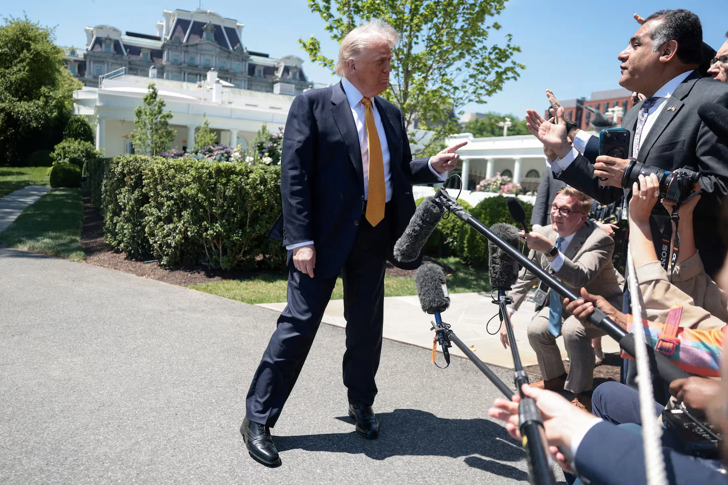 Trump lands in Beijing with trimmed ambitions, seeking deals as Taiwan looms