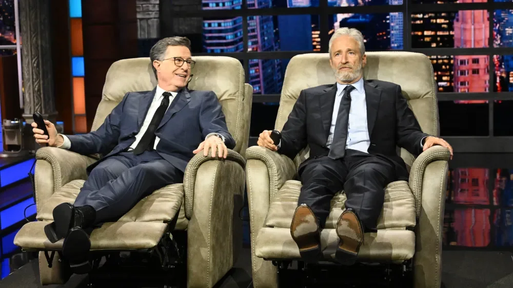 Jon Stewart Honors Colbert’s Final Week With Luxury Recliners and Andra Day Performance