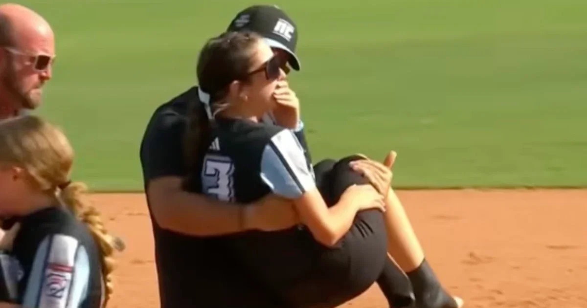 Dad’s on-field carry after daughter’s injury goes viral at softball world series