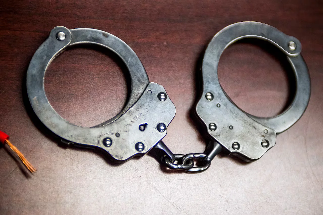Gas station clerk charged with manslaughter for trapping victims before fatal shooting.