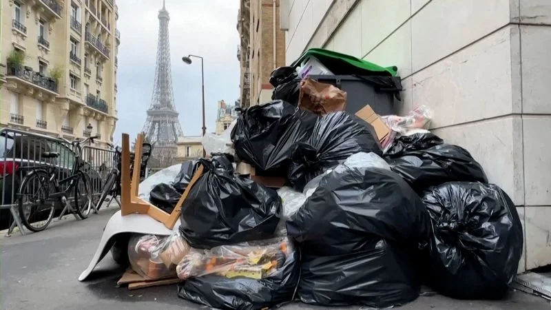 Paris struggles with massive garbage pile-up on its streets.