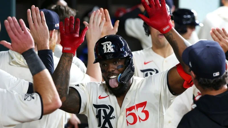 Adolis García's historic 3 HRs and 8 RBIs lead Rangers to 18-3 victory over A's.