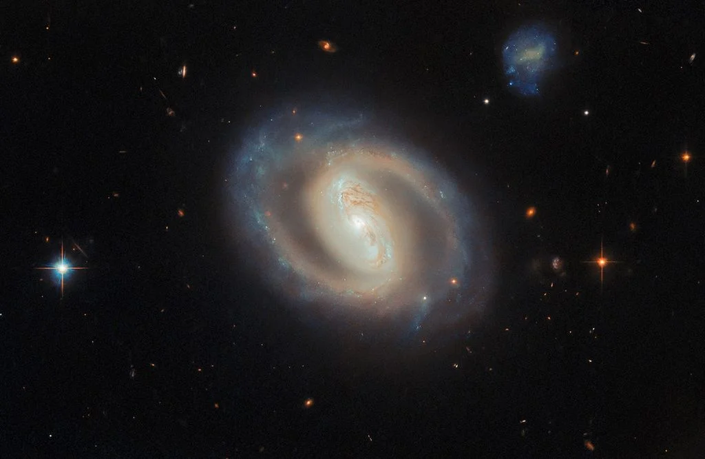 Hubble captures a glowing barred spiral galaxy with a blazing nucleus