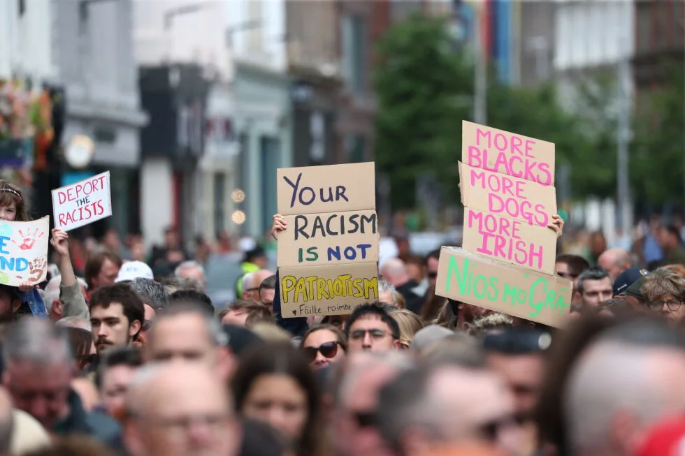 Belfast stands against xenophobia after stabbing spurs anti-immigrant rioting